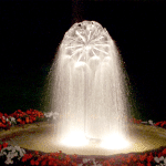Illuminated water mini-sphere in a garden