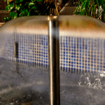 Detail of the laminar effect of water in a mushroom-shaped fountain nozzle