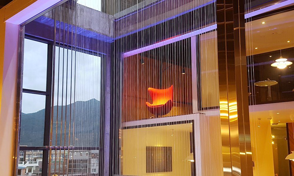 A striking water curtain within a commercial gallery, employed as a decorative feature