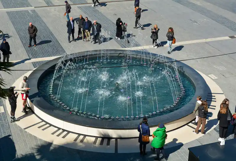 Interactive and musical fountain installed with our fountain equipment where children engage with a piano and water features