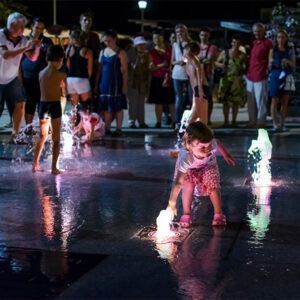 A child playing in an fountain , walk-through fountain