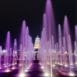 Several illuminated water jets in a fountain or walk-through fountain