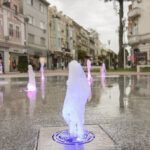 Waterboy with a foamy stream in a fountain